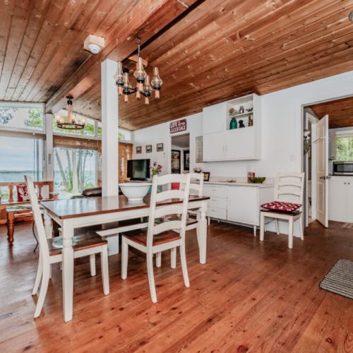 Bright and spacious, this open-concept cottage layout features lake views, a full dining area, and cozy cottage vibes for memorable group getaways.