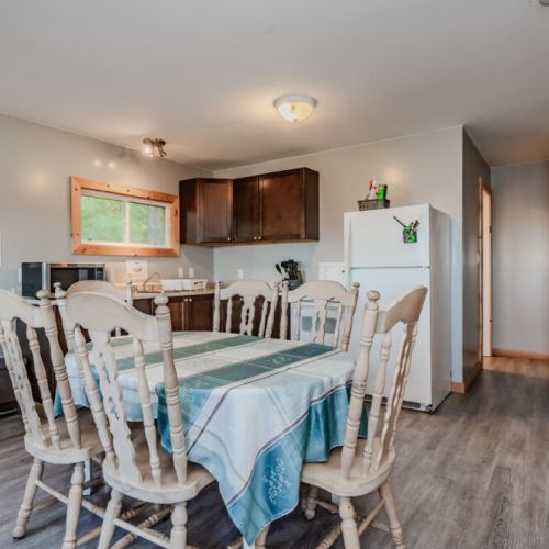 The rustic wooden staircase adds charm and provides access to additional rooms in the cabin.