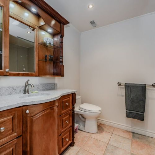 Well-appointed bathroom with wood vanity, full shower, and soft lighting—perfect for refreshing after a day of adventure.