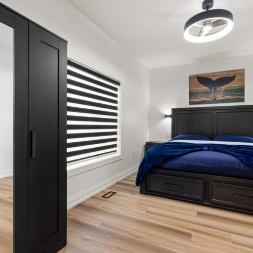 A comfortable bedroom with a king bed and blackout blinds for a restful night's sleep.