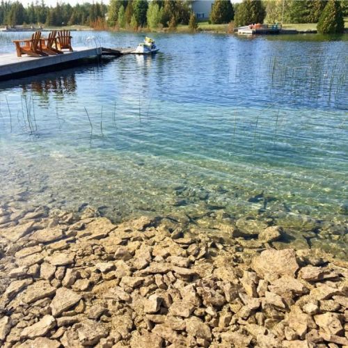The crystal-clear shoreline offers beautiful shallow water and easy access for swimming and exploring.