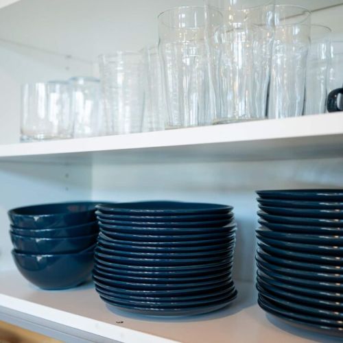 Well-stocked with dishes, glasses, and essentials—no need to pack the kitchen sink.