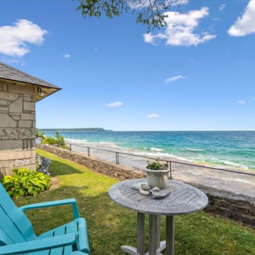Adirondack chairs and a table for relaxing right at the water’s edge.