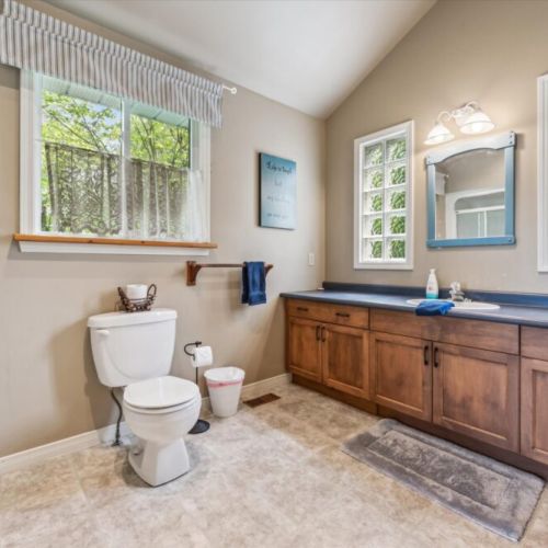 Spacious main bathroom featuring a spacious sink, ample counter space, and a bright, airy feel.
