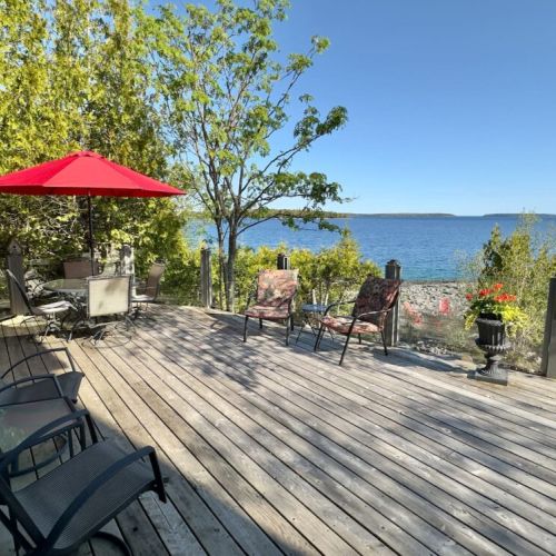 One of the best spots at the cottage. Enjoy outdoor dining, morning coffee, or a glass of wine while taking in sweeping views of the water and surrounding natural beauty.