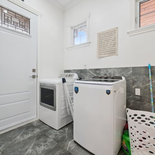 Convenient laundry area with washer and dryer for longer stays and added comfort