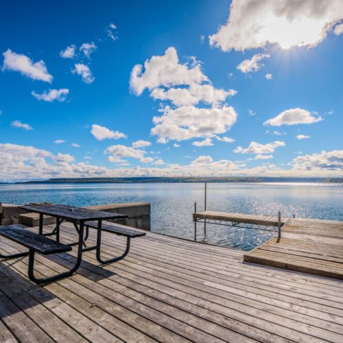 A serene lakeside dock, perfect for lounging or launching into the water.