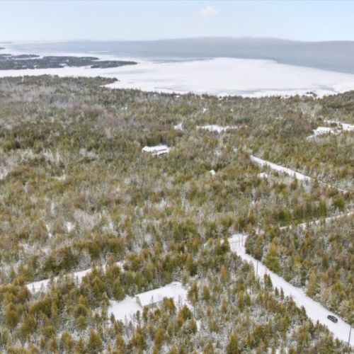 Sweeping aerial view of the Bruce Peninsula landscape, showcasing the cottage’s beautiful natural surroundings near the Lake Huron shoreline.