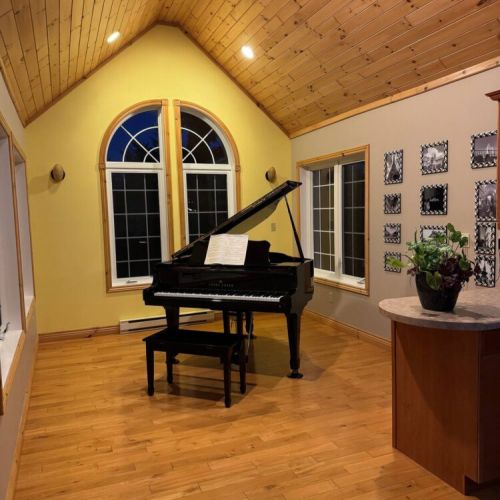 Elegant grand piano nook under cathedral ceilings—perfect for a serene retreat or romantic escape.