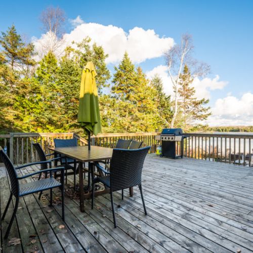Enjoy the your surroundings while dining on the back deck. The waterfront vista and the sounds of nature add an extra layer of serenity to your meal, creating a dining experience like no other.