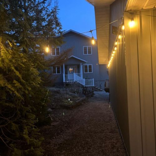 Magical cottage evenings await—enjoy warm outdoor lighting and a charming entrance that welcomes you home after a day of exploring
