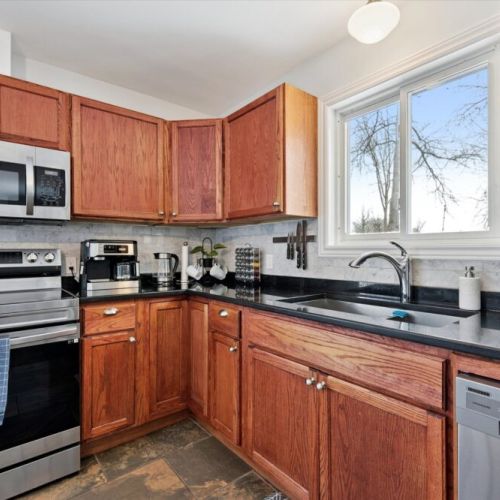 Fully refreshed kitchen with modern countertops, stainless-steel appliances, and plenty of space to prep meals.