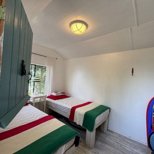 Two twin beds with classic striped blankets for guests or kids.