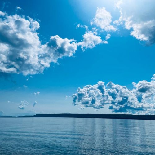 Start your mornings with breathtaking views like this—fluffy clouds dancing over the calm, crystal-clear waters of Georgian Bay. A perfect moment of peace awaits you every day at Treetop Hideaway!