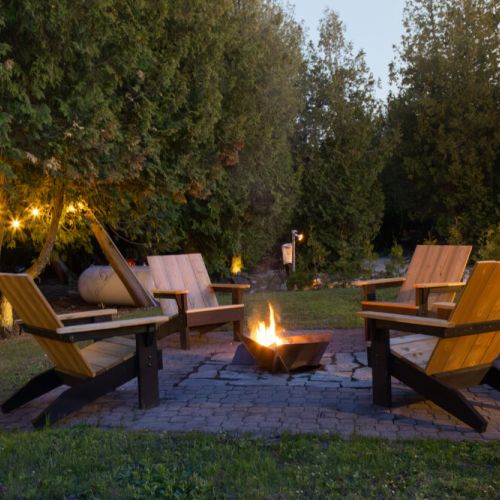 This fireplace, near the BBQ, pergola, and dining area, sets the mood for memorable nights. Share endless conversations with friends and family under its warm glow.