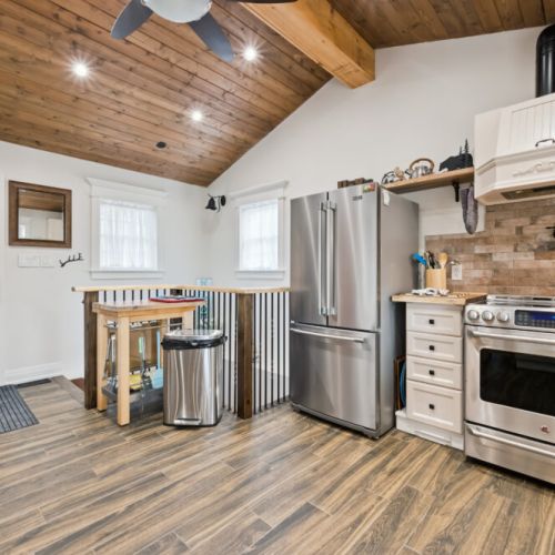 From the entryway, stairs lead down to the lower level, where you'll find the gym, games room, and hot tub area.