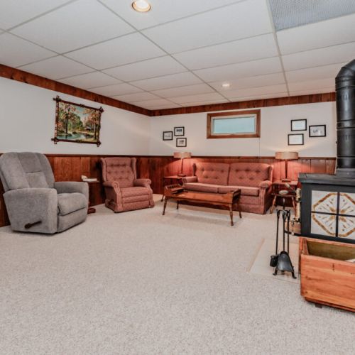 Gather with family in the rustic, wood-accented lounge complete with a cozy wood stove—perfect for chilly nights on your lakeside vacation.