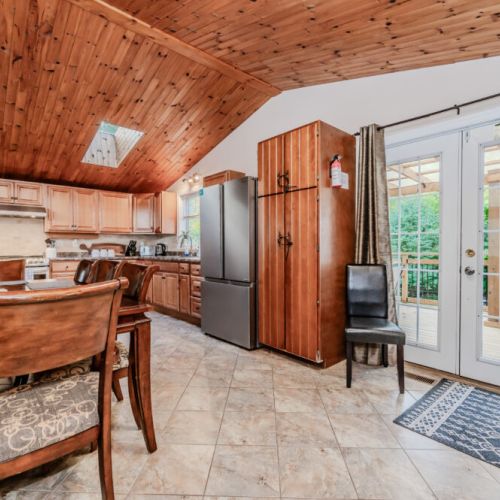 Enjoy cooking in this spacious, well-equipped kitchen with modern appliances, beautiful wood cabinetry, and a skylight that lets natural light flow in.