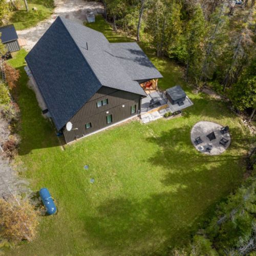 The cottage's large yard is ideal for outdoor activities, with a hot tub and fire pit ready for your relaxation.