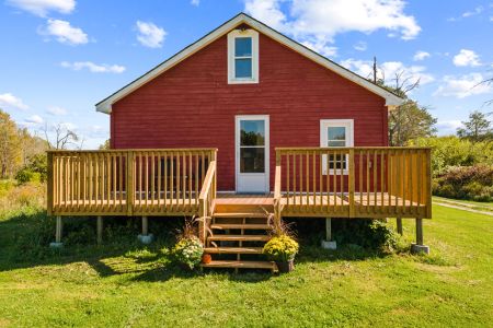 The spacious deck provides easy access between the farmhouse and the beautiful outdoor surroundings.