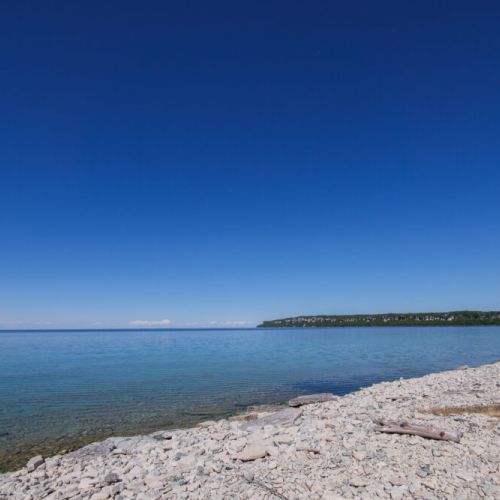 Miles of crystal-clear water and rugged limestone shoreline create an unforgettable Bruce Peninsula escape.