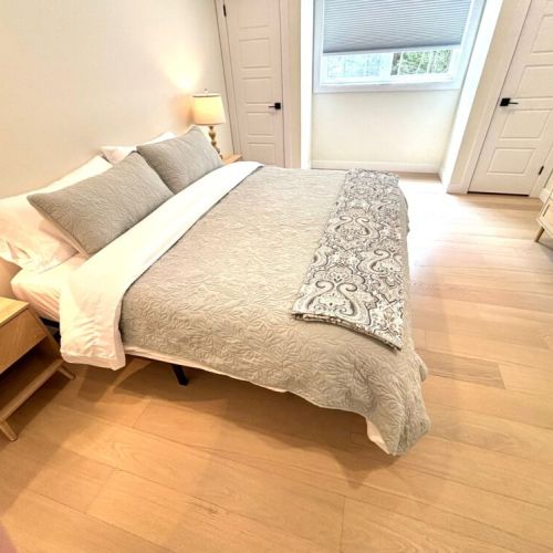 A restful haven – this king-size bed features soft bedding, natural light, and ample space for a peaceful night’s sleep.