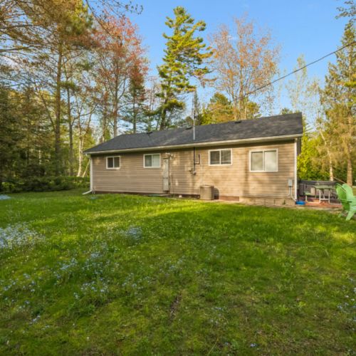 A large grassy yard provides plenty of space for outdoor games, kids to play, and enjoying the fresh air.
