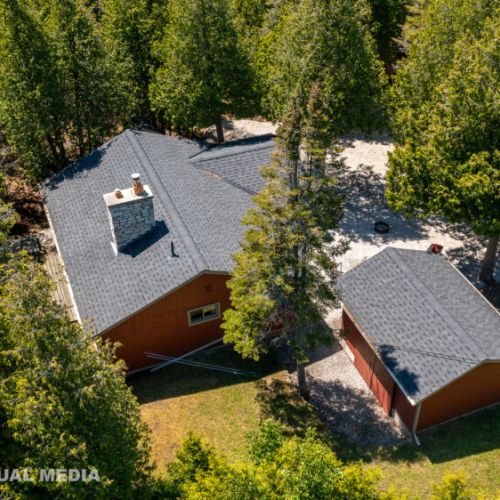 Spacious property with plenty of outdoor space, surrounded by peaceful forest canopy.
