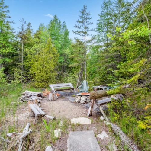 Tucked into the woods, enjoy s’mores, storytelling, and stargazing around the rustic fire pit—complete with handcrafted wooden benches and natural stone surround.