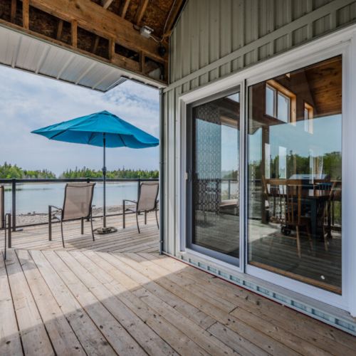 Relax on the deck with outdoor furniture and umbrella, overlooking Lake Huron. Perfect for morning coffee or evening drinks.