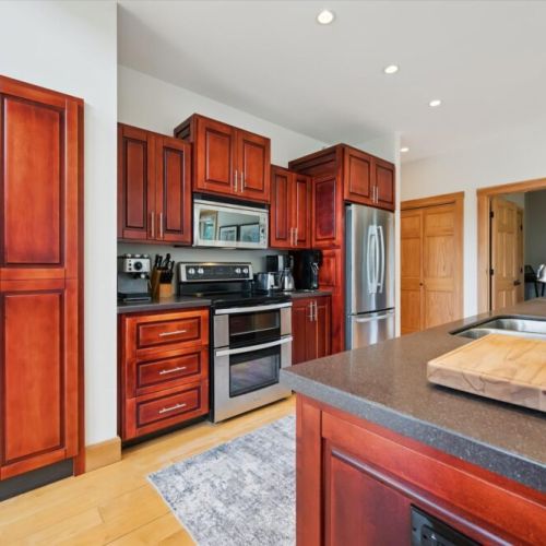 Modern kitchen featuring stainless steel appliances and beautiful wood cabinetry.