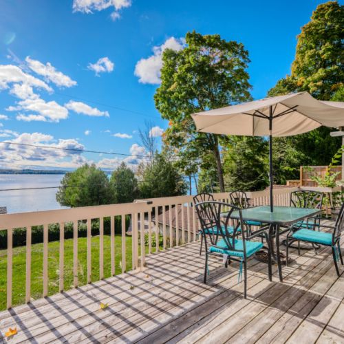 Relax on the spacious deck with outdoor dining, overlooking stunning waterfront views.