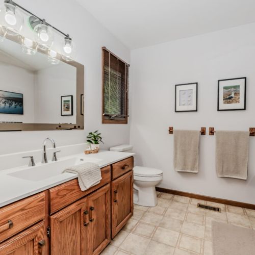 Refresh in the large main bathroom featuring a luxurious tub, double vanity, and tranquil decor for a spa-like experience.