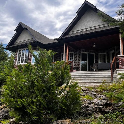 Covered front porch with seating, perfect for morning coffee or evening relaxation
