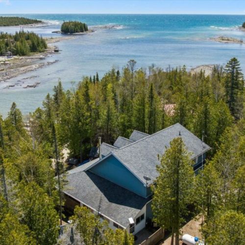 Stunning aerial perspective highlighting the property’s beautiful waterfront location along Bradley Harbour.