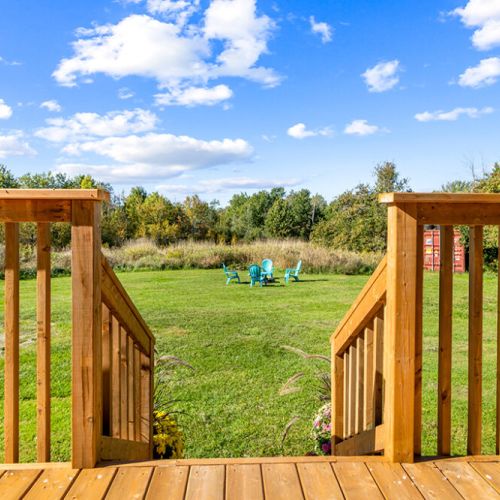 Step off the deck and into the expansive backyard, with the firepit just a short walk across the lawn.