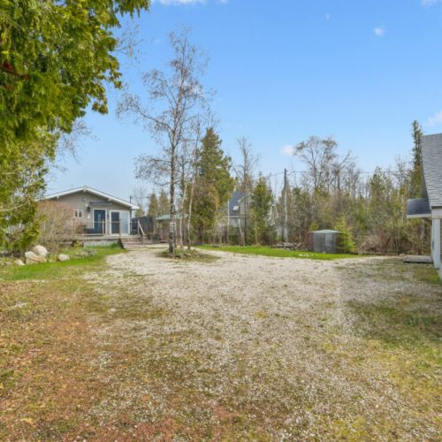 Generous private lot offering plenty of parking and a secluded cottage retreat setting.