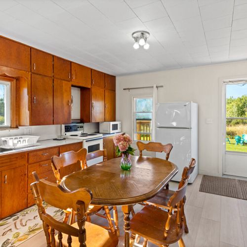 Enjoy meals together around the dining table, surrounded by the warm character of this classic country kitchen.