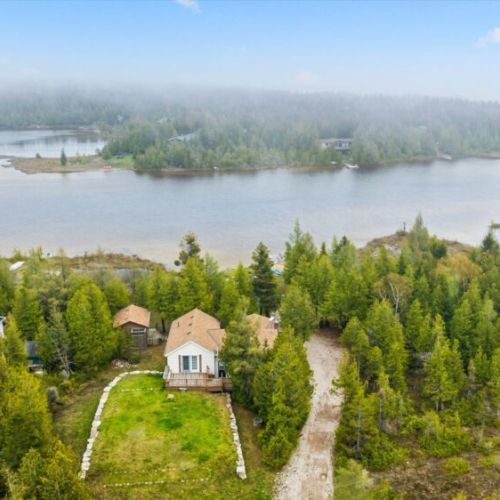 Surrounded by mature trees and overlooking the water, this secluded retreat combines nature, relaxation, and unforgettable views.