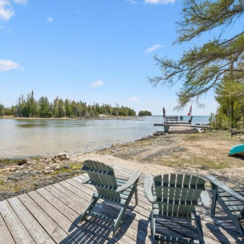 Enjoy beautiful shoreline views and direct water access from the private beachfront seating area.