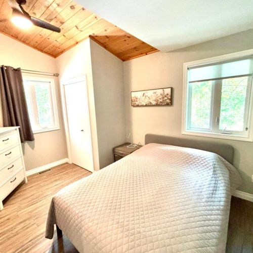 Natural light fills this cozy space, complete with a corner closet and all the essentials for a comfortable night in.