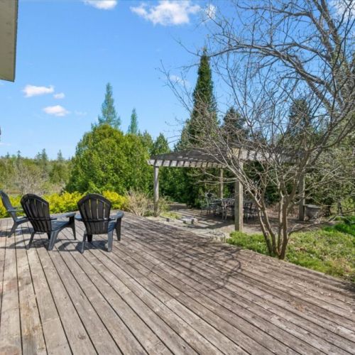 Large outdoor deck with comfortable seating and tranquil forest views.