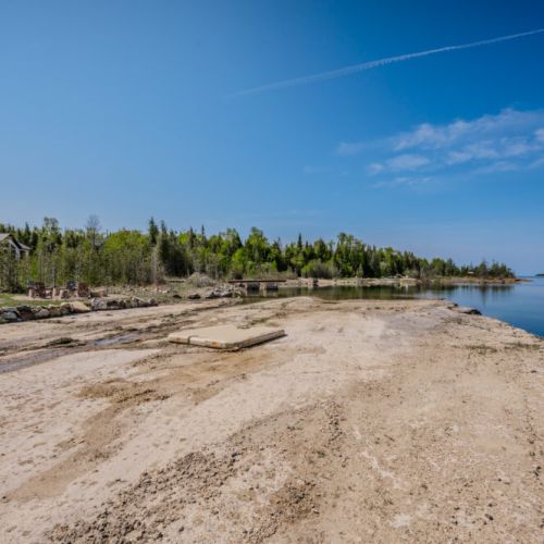 A broad shoreline invites you to relax by the calm waters, making it perfect for sunbathing, swimming, or water activities.