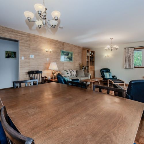 Gather around the large dining table with your group—perfect for shared dinners and quality time during your lakeside getaway.