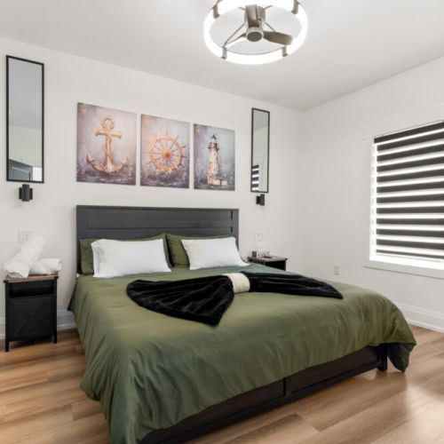 Relax in a cozy king bedroom with elegant décor and plenty of natural light.