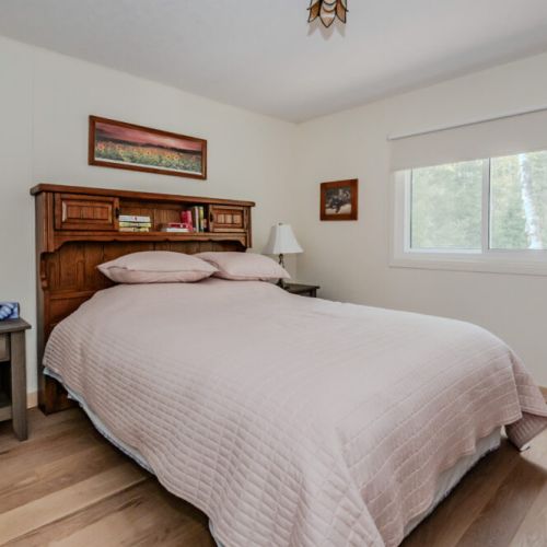 The master bedroom is a restful retreat featuring a plush bed and soothing decor, providing a perfect sanctuary for relaxation after a day of exploration.