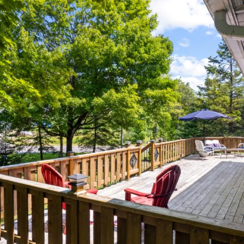 Enjoy peaceful views of the trees and lake from the spacious deck.