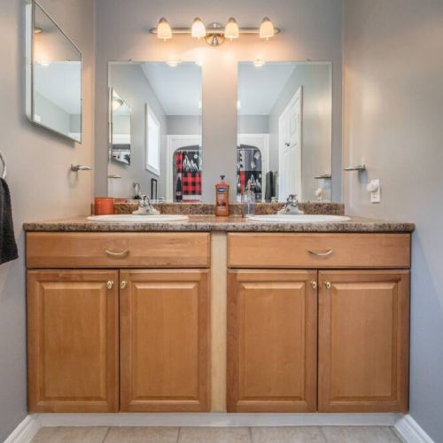 The Master bedroom ensuite bathroom with double sinks and a walk-in shower.