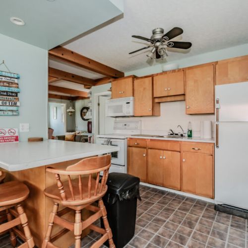 The fully equipped kitchen features a modern breakfast bar and all the essentials for preparing delicious meals. The adjacent cozy nook is perfect for morning coffee and casual dining.