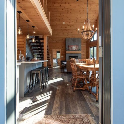 A warm welcome—step inside to soaring ceilings, natural wood finishes, and open-concept living.
